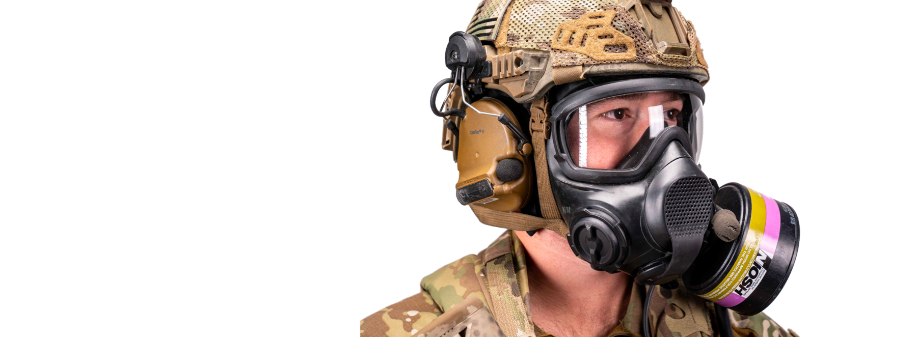 Person wearing a military helmet and AirBoss LBM gas mask