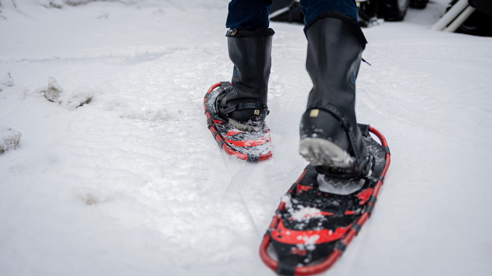 Person wearing snowshoes and AirBoss ThermoBoss™ boots on a snowy surface