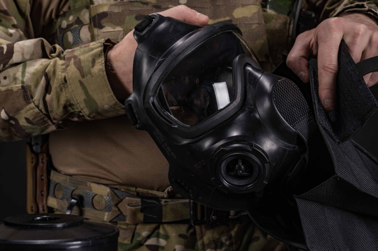 Soldier placing the AirBoss LBM gas mask in a carrying case. 
