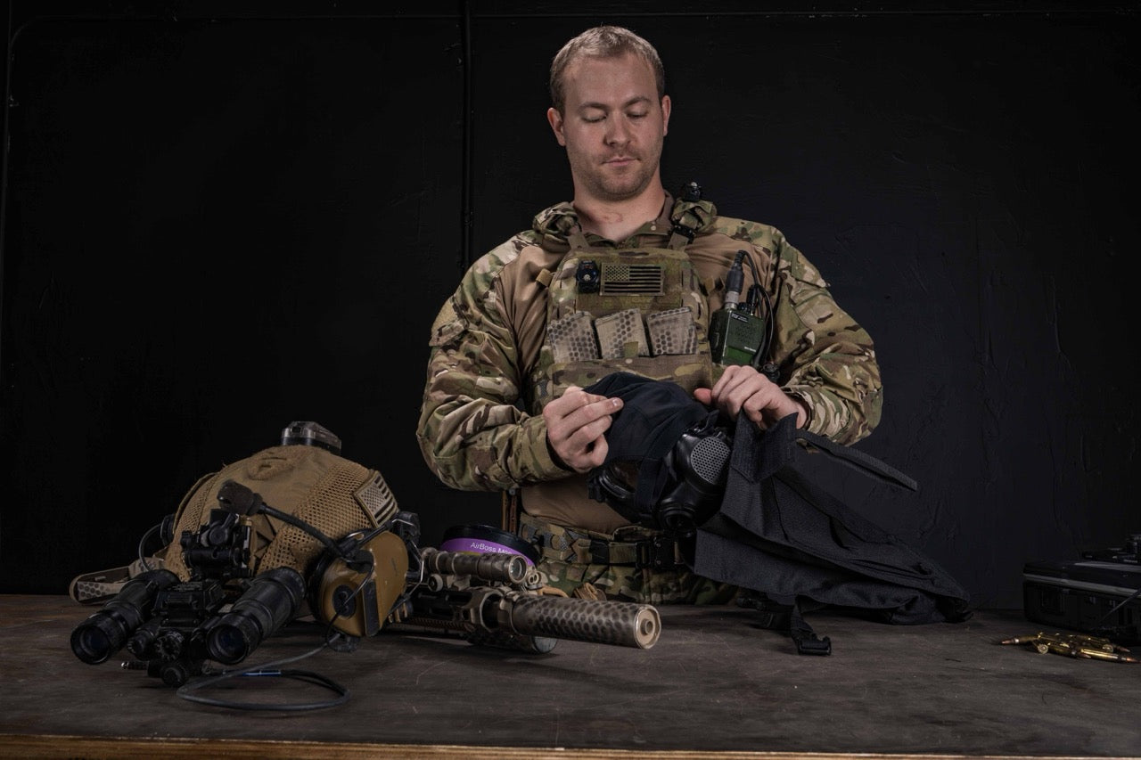 Soldier placing the AirBoss LBM gas mask in it's carrying case. 