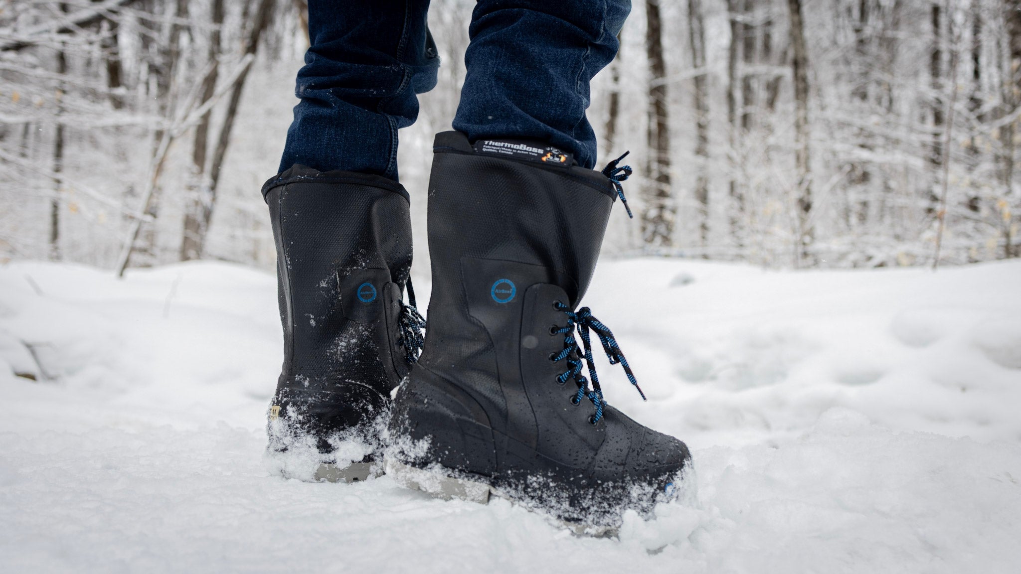 Person wearing black AirBoss ThermoBoss™ boots in a snowy forest